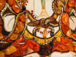 Panel with amber in combination with lurex and Swarovski stones “Four-armed Avalokiteshvara”