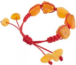 Amulet bracelet with red thread and polished honey-colored amber