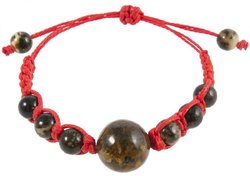 Amulet bracelet with a red thread and greenish amber balls
