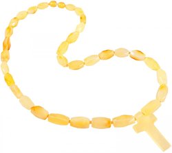 Beads made of light multifaceted amber stones with a cross