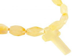 Beads made of light multifaceted amber stones with a cross