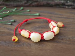 Amulet bracelet with red thread and light polished amber