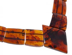 Beads with figured cognac-colored amber stones (with a diamond-shaped center)