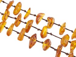 Three rows of beads made of polished amber stones