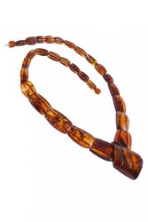 Beads made of cognac-colored amber stones (center with relief carving)