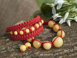 Amulet bracelet with amber balls and red thread