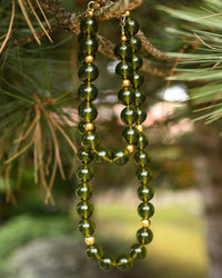 A necklace of greenish amber balls