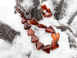 Beads made of dark amber stones in the shape of a heart