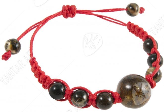 Amulet bracelet with a red thread and greenish amber balls