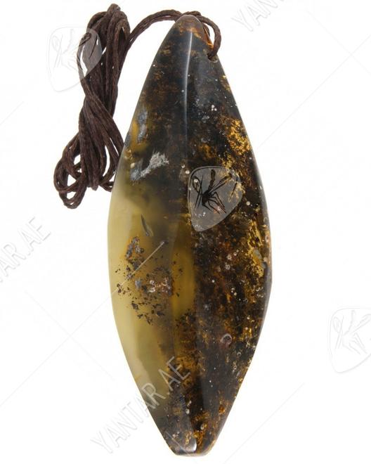 Pendant made of polished amber stone in dark shades