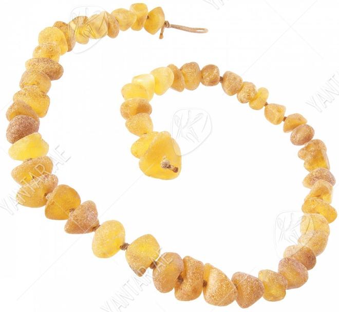 Stone beads made of light polished amber through a knot (medicinal)