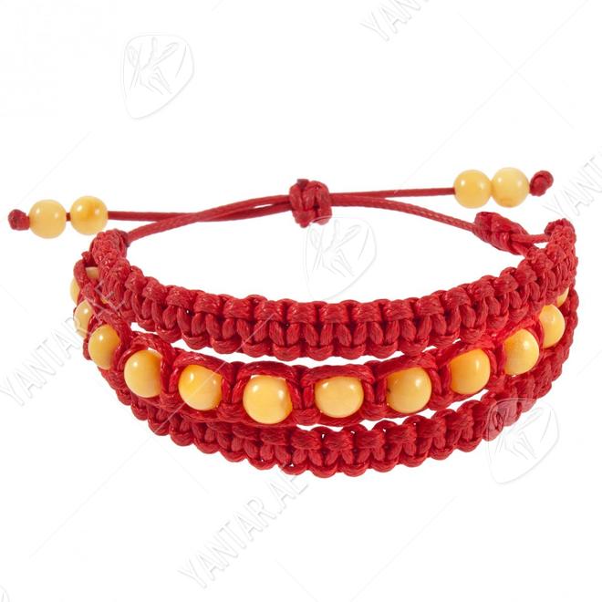 Amulet bracelet with amber balls and red thread