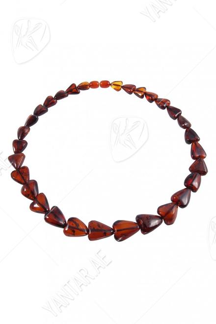 Beads made of dark amber stones in the shape of a heart