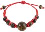 Amulet bracelet with a red thread and greenish amber balls