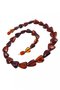 Beads made of dark amber stones in the shape of a heart