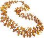 Three rows of beads made of polished amber stones