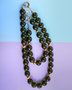 A necklace of greenish amber balls