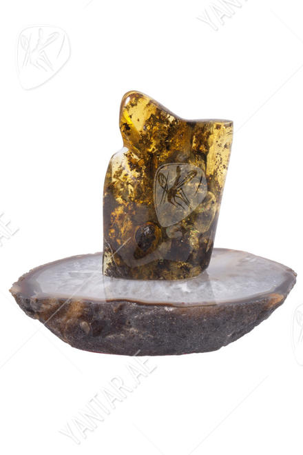 Amber souvenir with inclusion on a stand